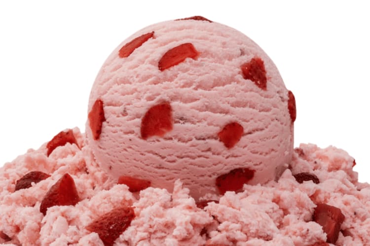 A scoop of strawberry ice cream with strawberry pieces