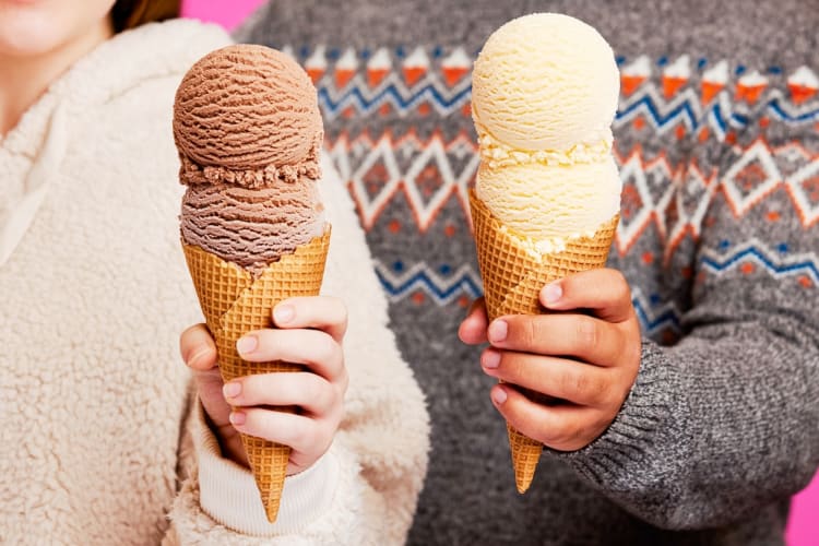Two people holding ice cream cones