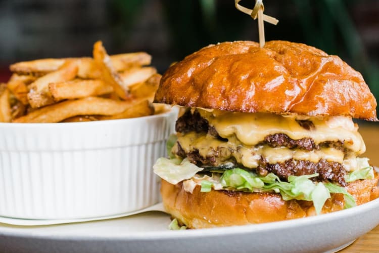 A double cheese burger with French fries