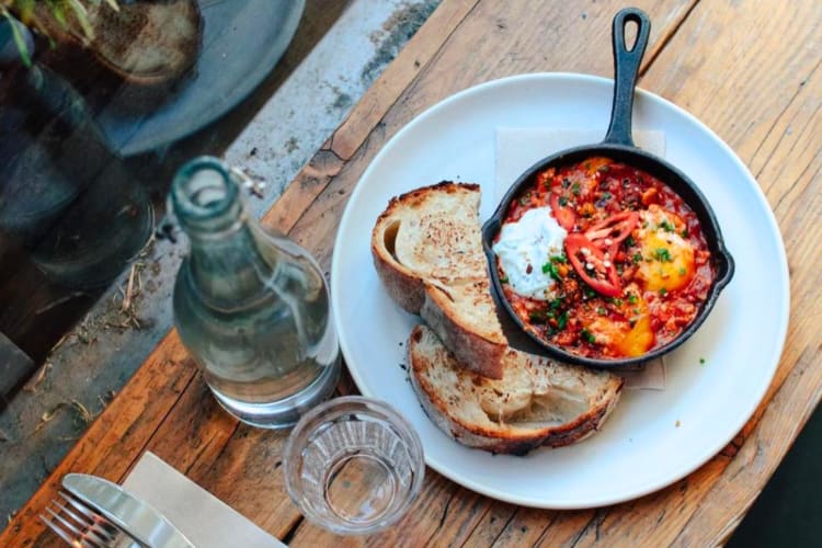 Shakshuka in a pan served with sourdough toast