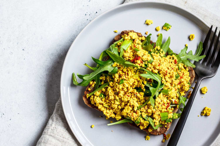 Tofu scramble on toast on a grey plate