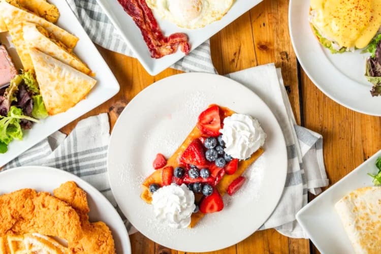 An aerial view of breakfast dishes with cloths under them on a table