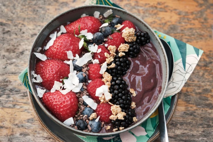 Açaí bowl topped with coconut and chia seeds.