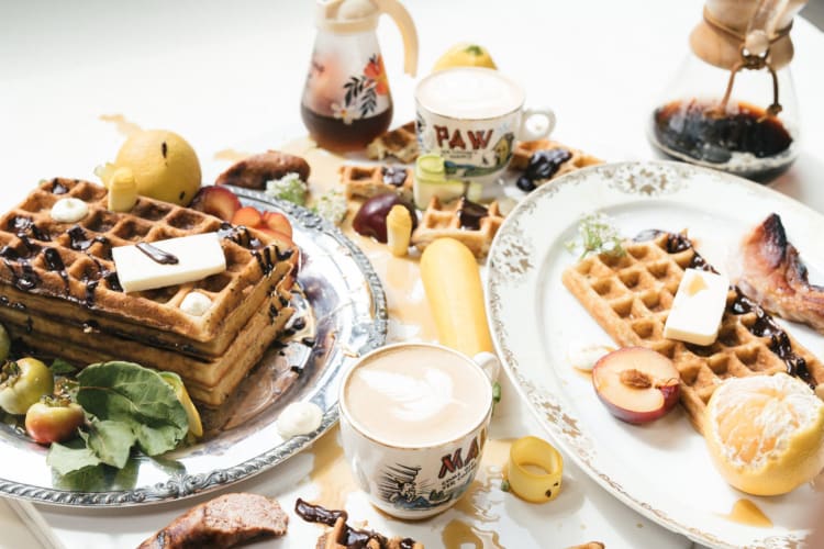 Waffles with fruit and breakfast drinks.