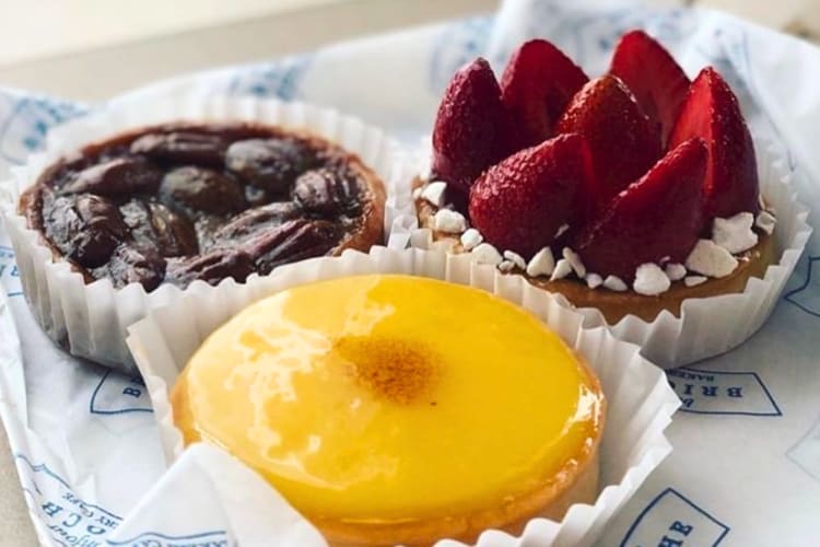 Three tartlets on white and blue paper