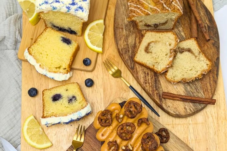 Coffee cakes on a table next to gold forks