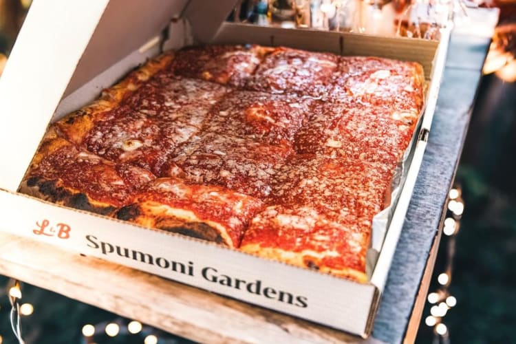 An open pizza box with square pizza slices in it