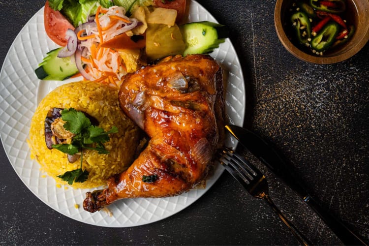 Vietnamese style oven-roasted chicken with yellow rice and salad on the side from D.C. restaurant Brothers Bistro