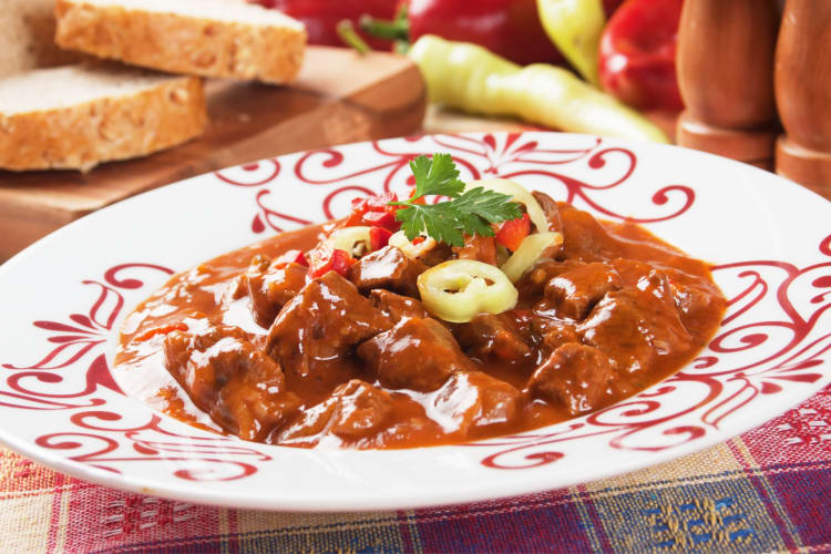 Meat stew in a red and white patterned plate