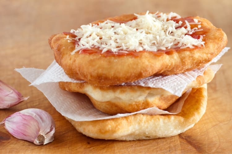 Fried dough with cheese next to garlic cloves