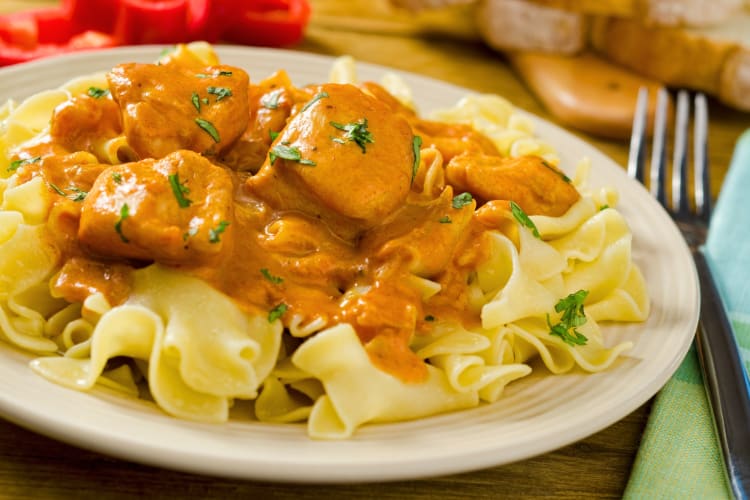 Chicken stew served on top of flat noodles