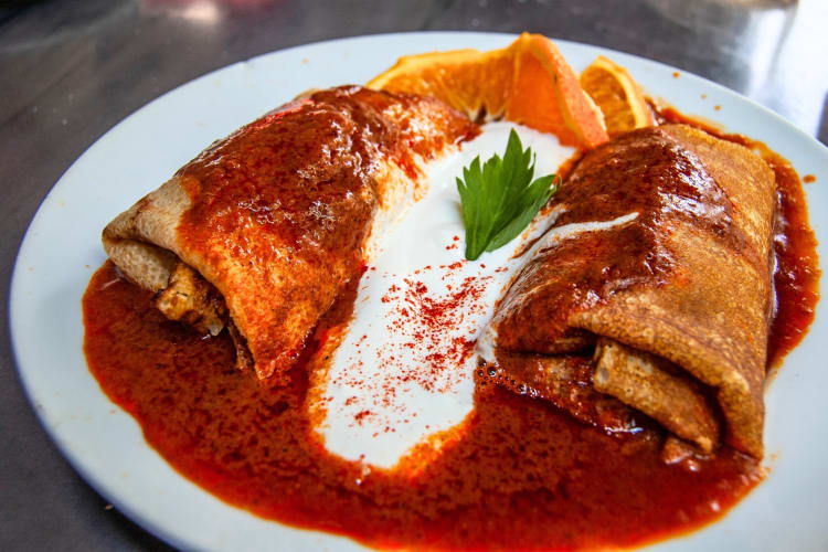 Savory crêpes with tomato sauce and sour cream