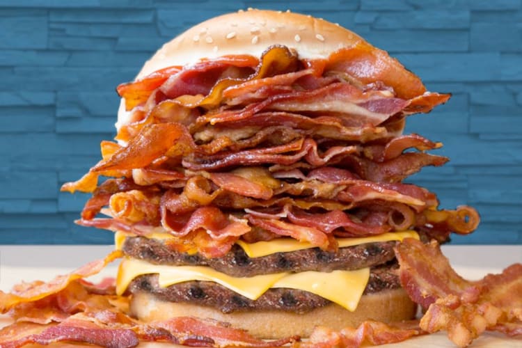 A cheeseburger with two patties and extra bacon