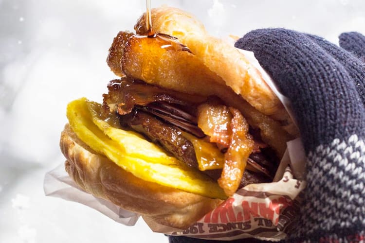 A breakfast sandwich with French toast sticks