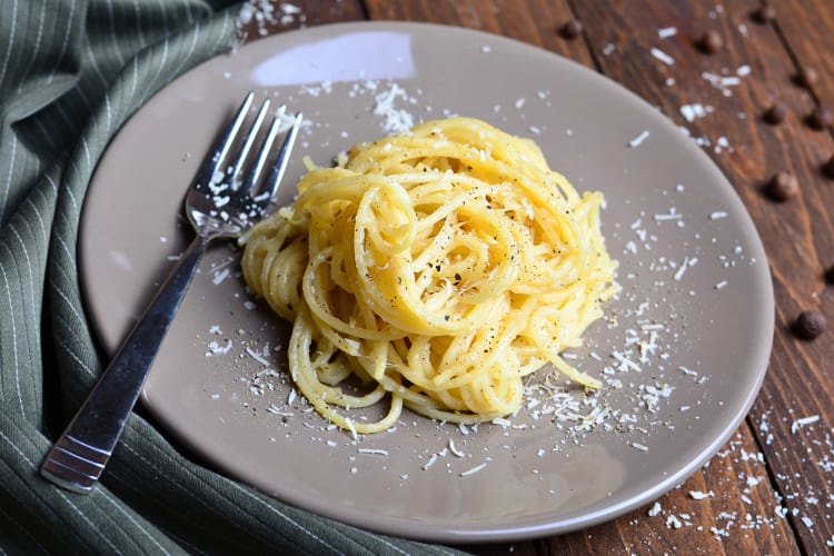 Cacio e Pepe on a plate with a fork next to it