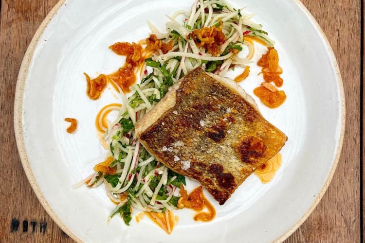 A piece of fish on thinly cut vegetables from Café Sebastienne