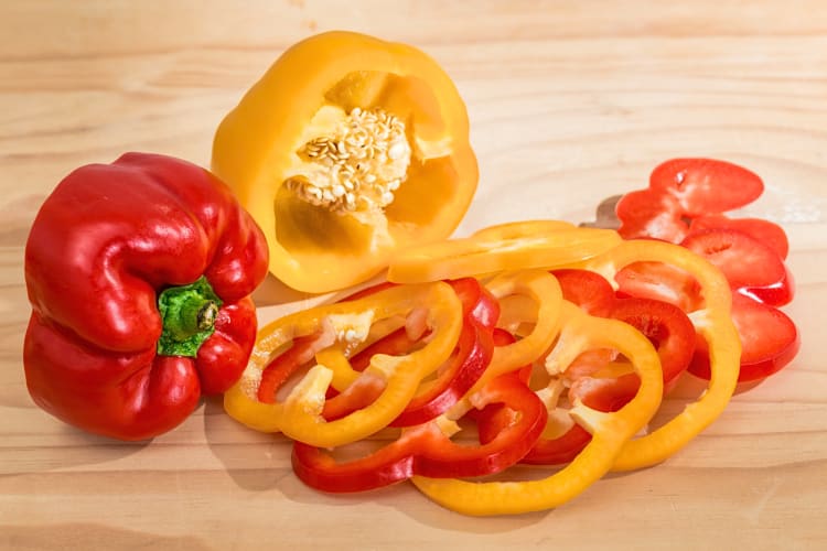 Red and yellow bell pepper cuts and halves