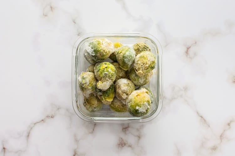 Aerial view of frozen Brussels sprouts in a tupperware