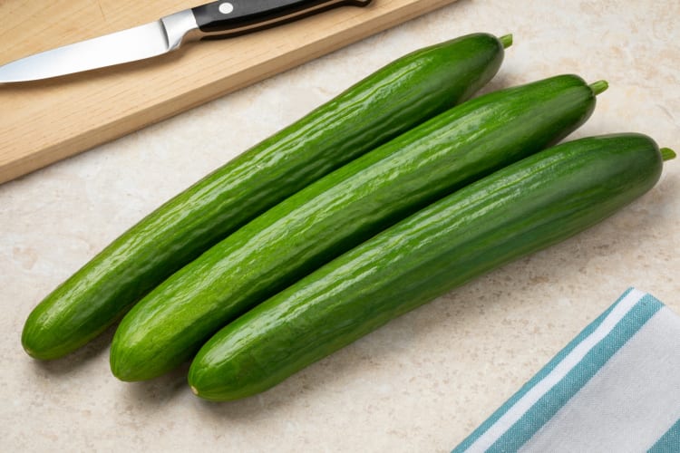 Three whole cucumbers on a table