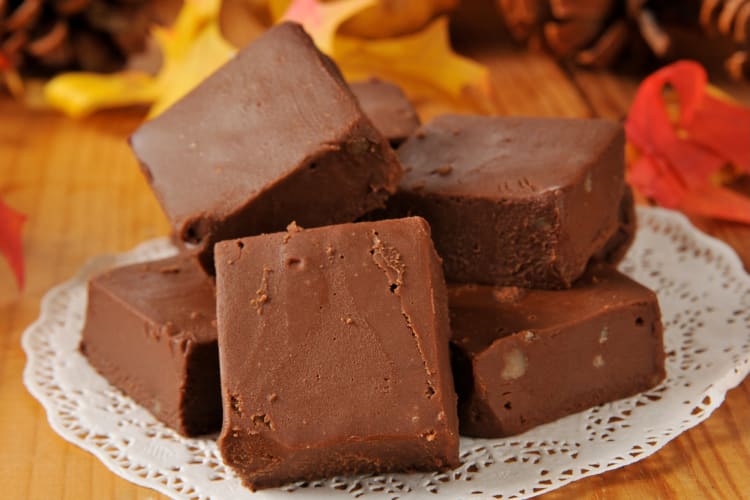 A plate with chocolate fudge stacked on it