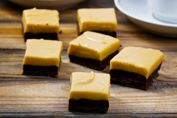 Chocolate and peanut butter fudge on a wooden surface