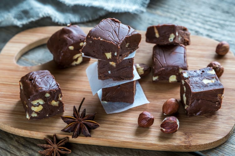 Chocolate fudge pieces on a wooden board