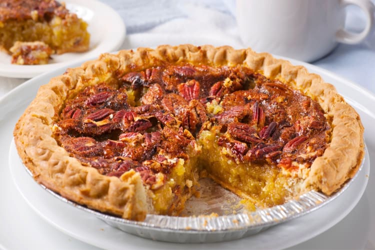 A pecan pie with a slice taken out of it