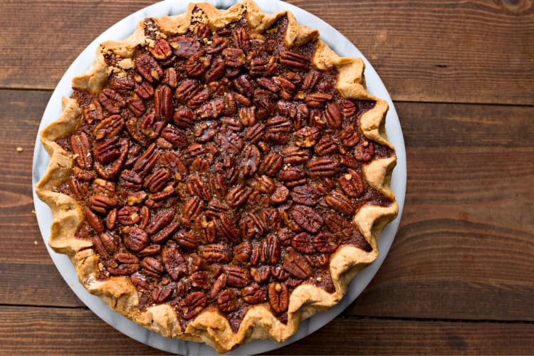 A whole pecan pie with crimped edges