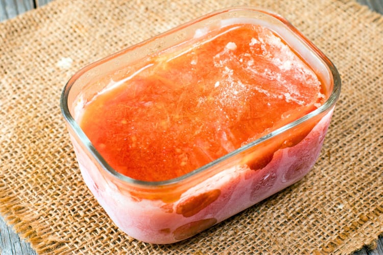 A glass container of frozen salsa