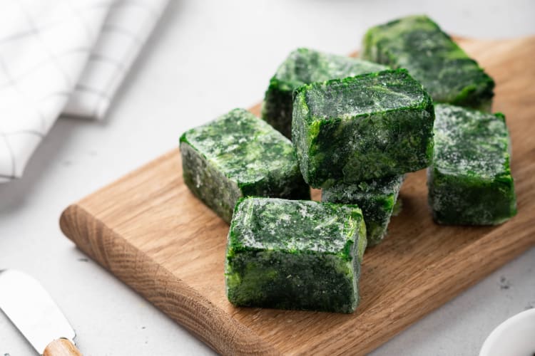 Frozen spinach cubes on a cutting board