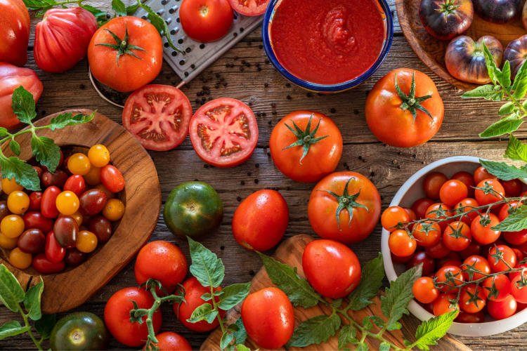 A selection of fresh tomatoes on a wooden table