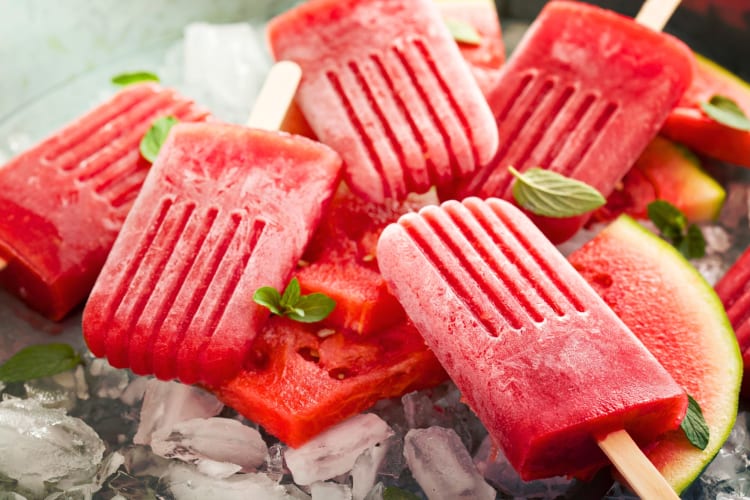 Frozen watermelon popsicles on top of ice