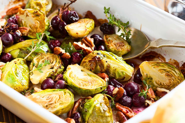 Roasted Brussels sprouts in an oven dish with herbs and spices