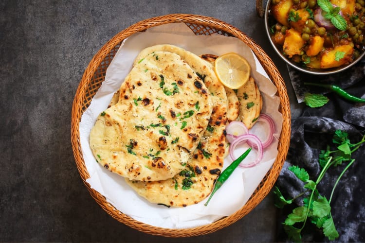A basked of naan breads.