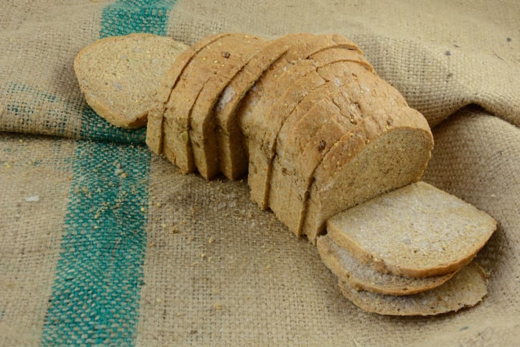 A whole load of sliced bread on burlap.