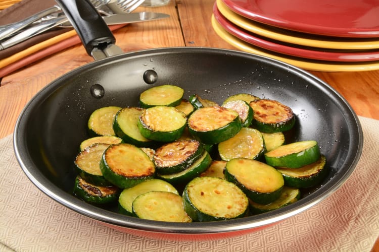 Cooked zucchini discs in a pan