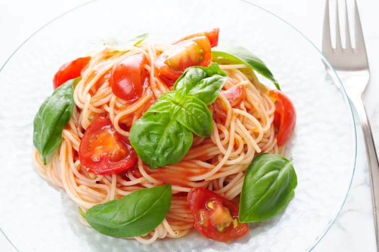 A bowl of capellini pomodoro with basil