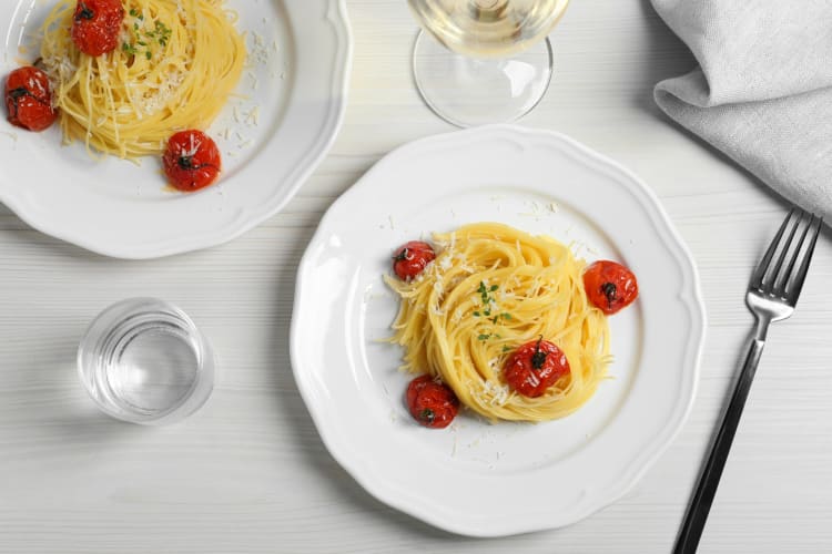 Capellini with tomatoes on white plates