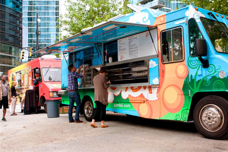 People in front of food trucks 