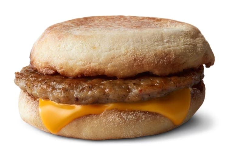 An English muffin with a sausage patty and American cheese
