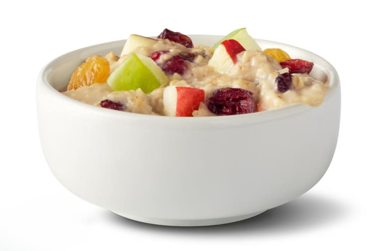A bowl of oatmeal with dried fruit