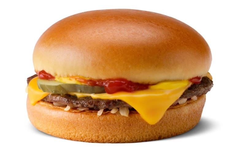 A cheeseburger with pickles, onions and ketchup
