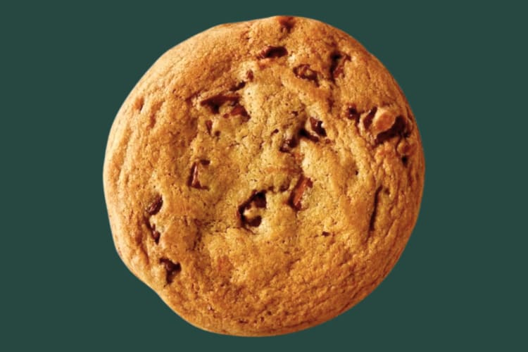 A chocolate chip cookie on a dark green background