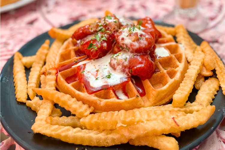 Waffle surrounded by fries, one of the best breakfasts in Playa del Carmen