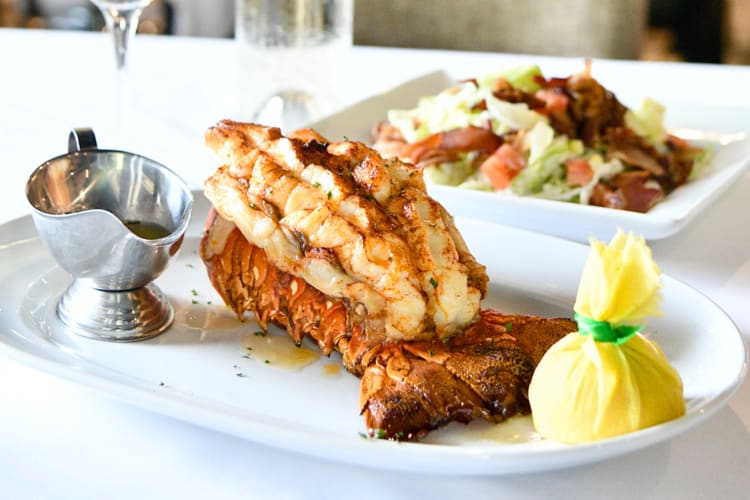 A lobster dish next to a salad