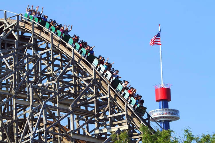 A rollercoaster next to a US flag