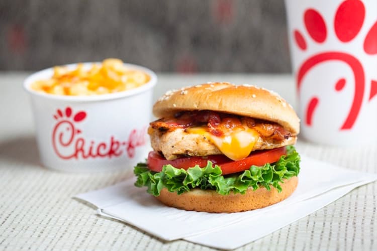 Chick-fil-A secret menu burger - a succulent chicken patty topped with crispy bacon, fresh lettuce, tomato, and zesty sauce, between toasted buns.