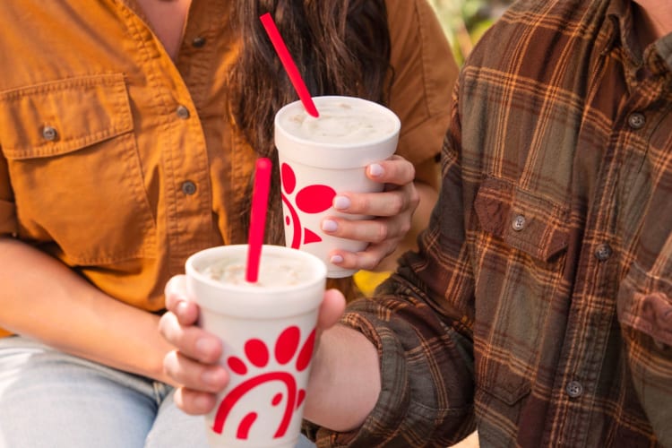 A couple enjoying Chick-fil-a milkshakes