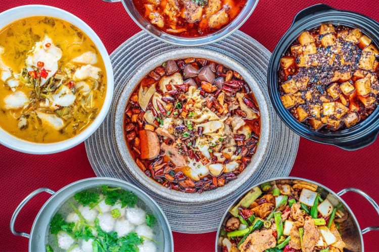 A selection of Asian dishes on a red table