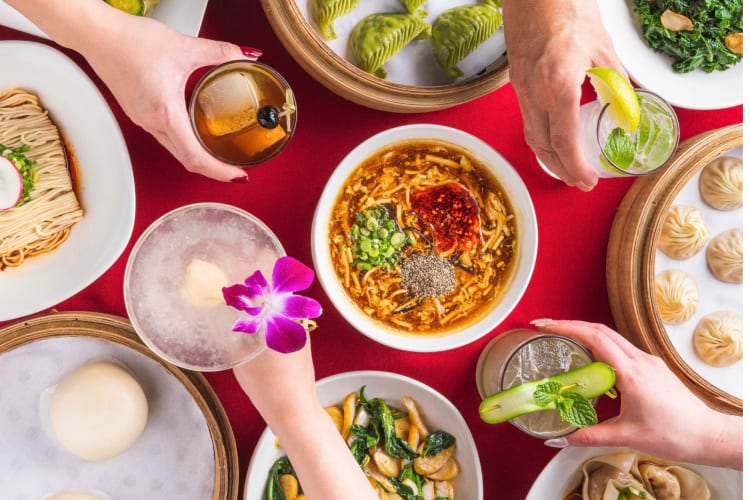 Drinks and Asian dishes on a red table
